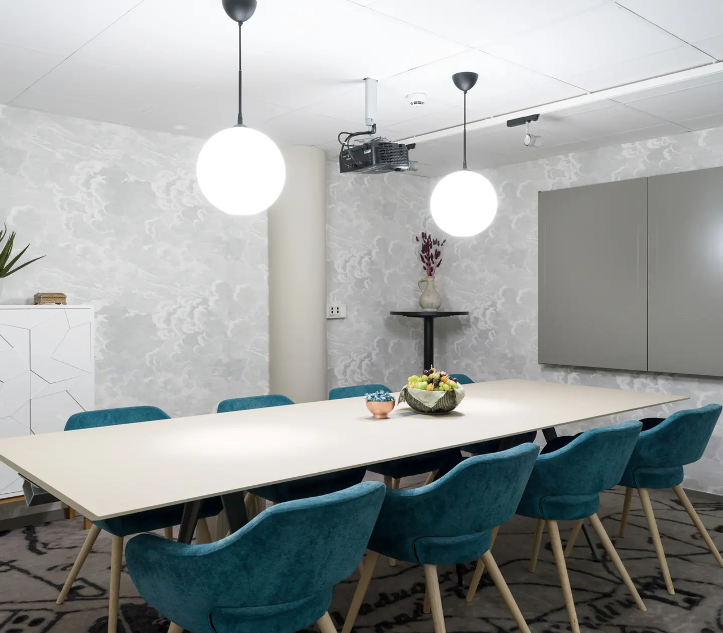Conference room with board seating, white table and blue chairs
