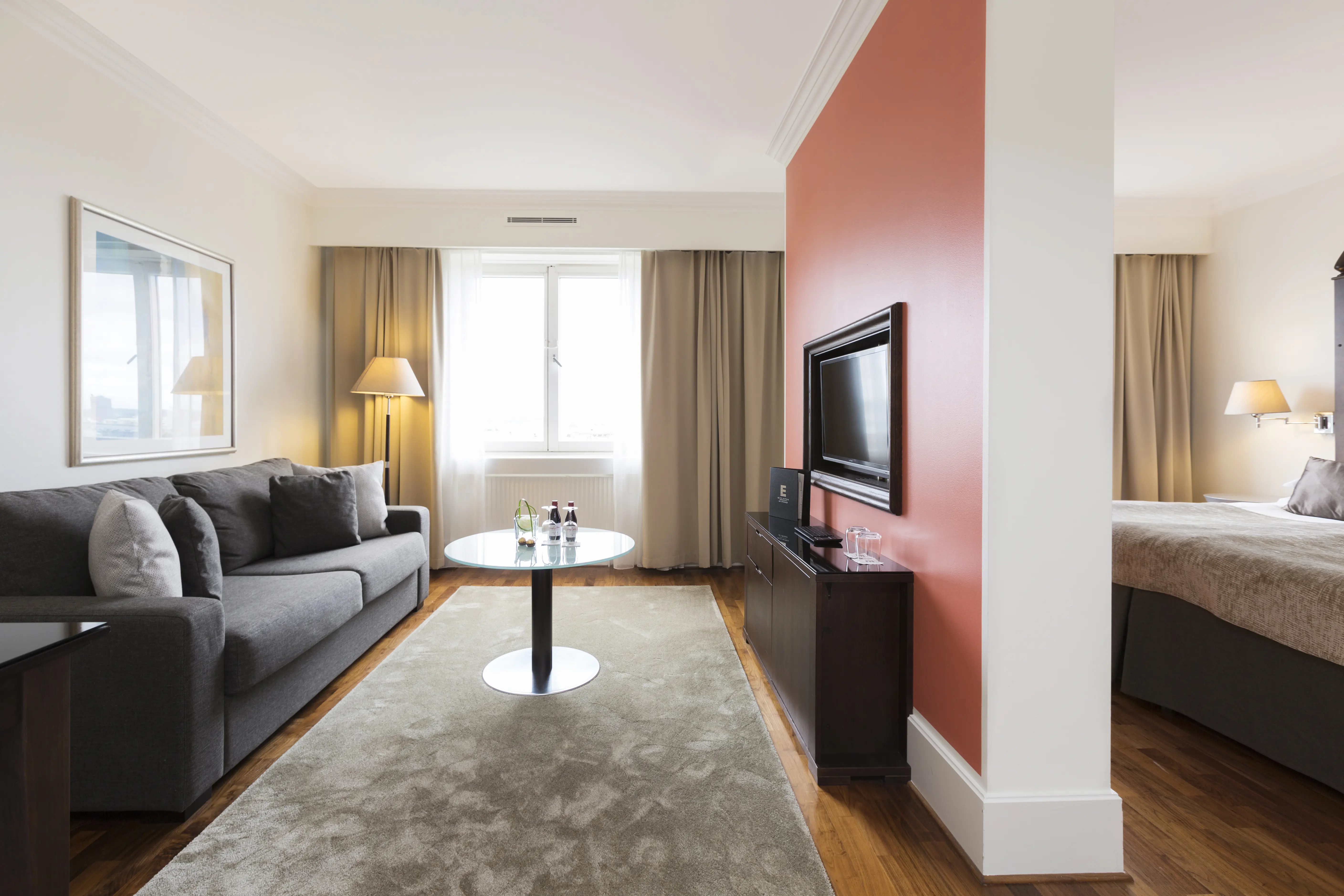 Suite with two rooms with bed, sofa and TV