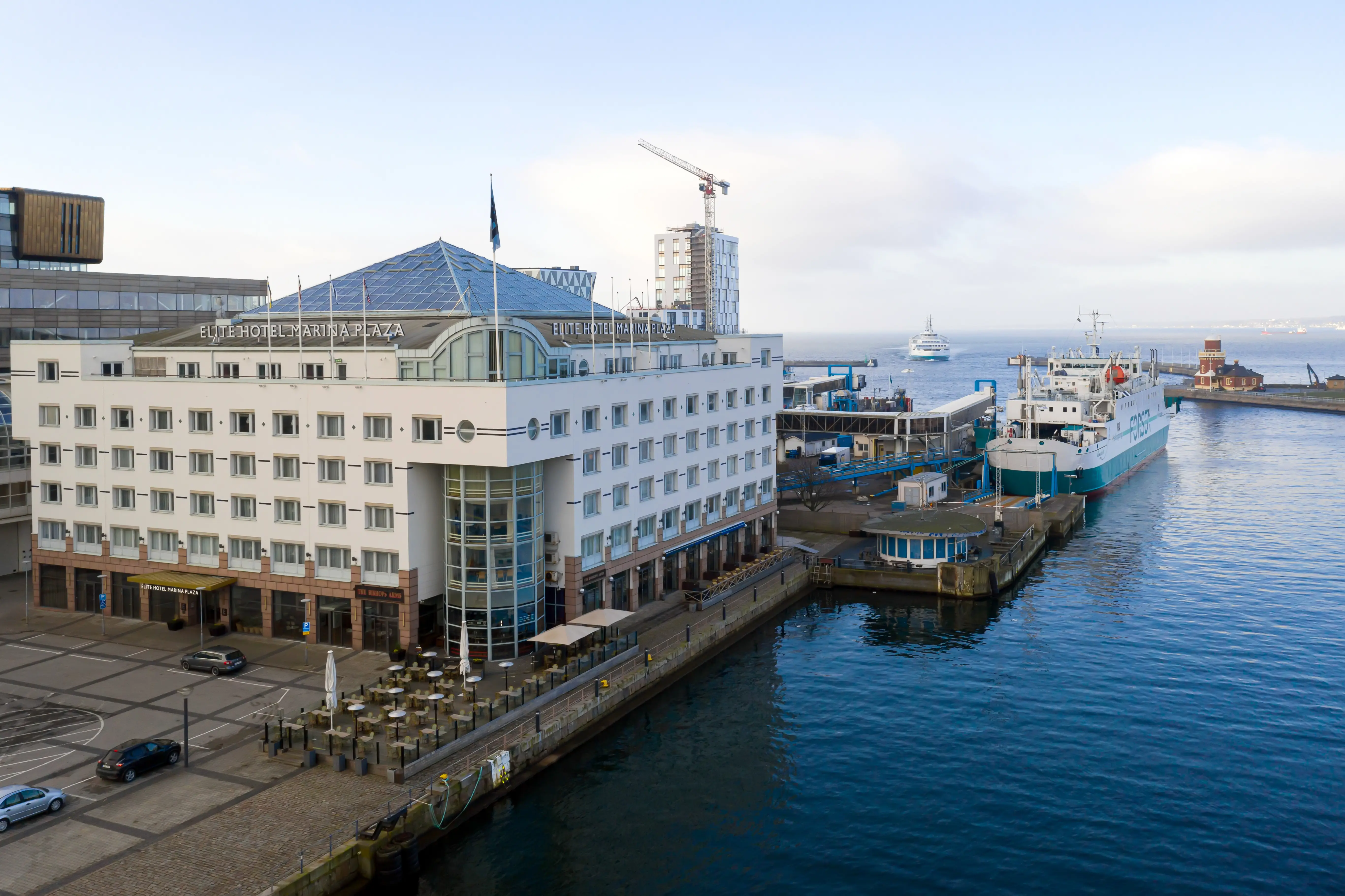 The white facade of the Elite Hotel Marina Plaza with Helsingborg's harbor in front