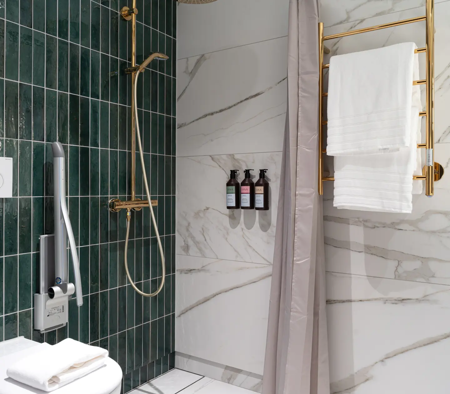 Bathroom with green tiles, white marble, and gold details.