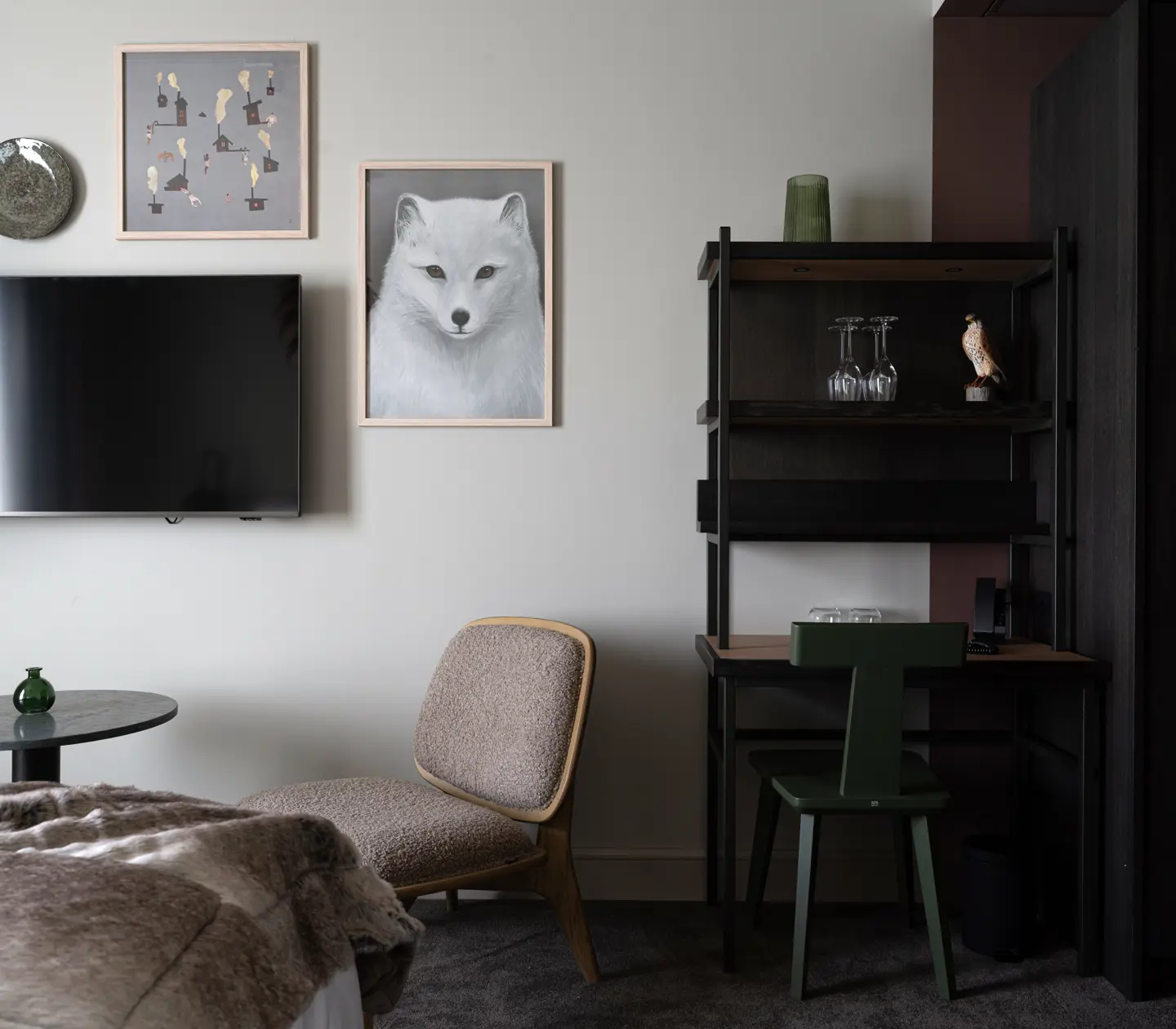 Aesthetic detail shot featuring a TV, artwork, and a bookshelf.