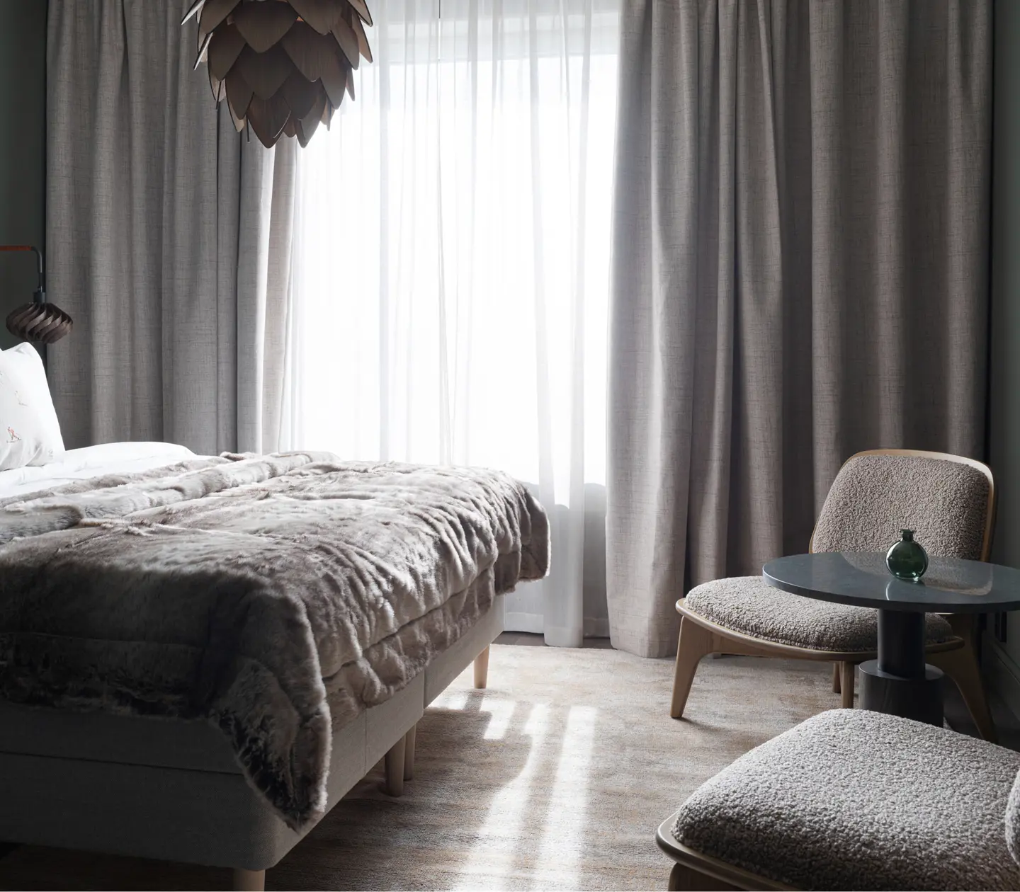 Overall view of a Deluxe room at Elite Hotel Frost featuring a bed, two chairs, and a TV.