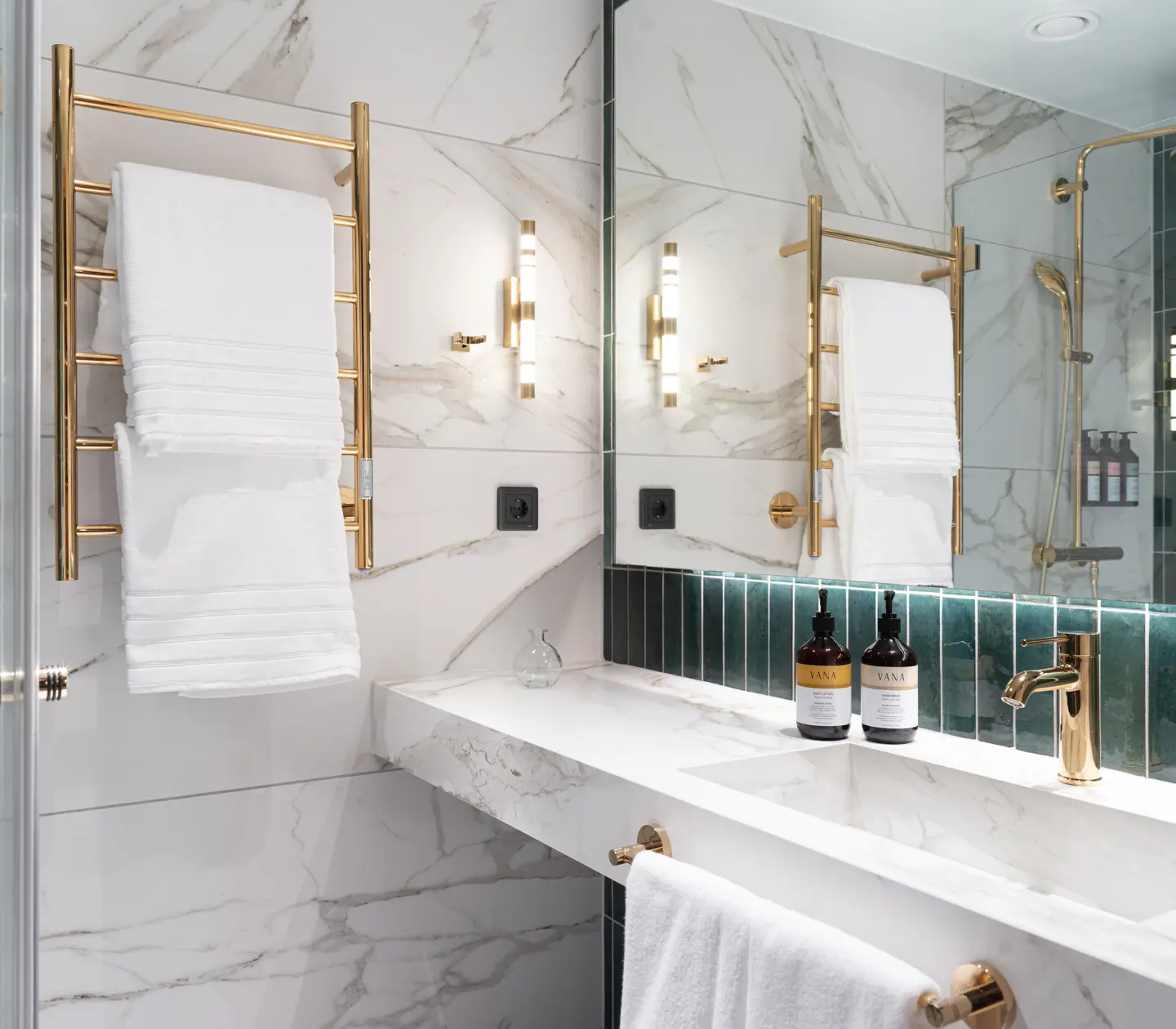 Standard bathroom in green and marble tones with gold accents.