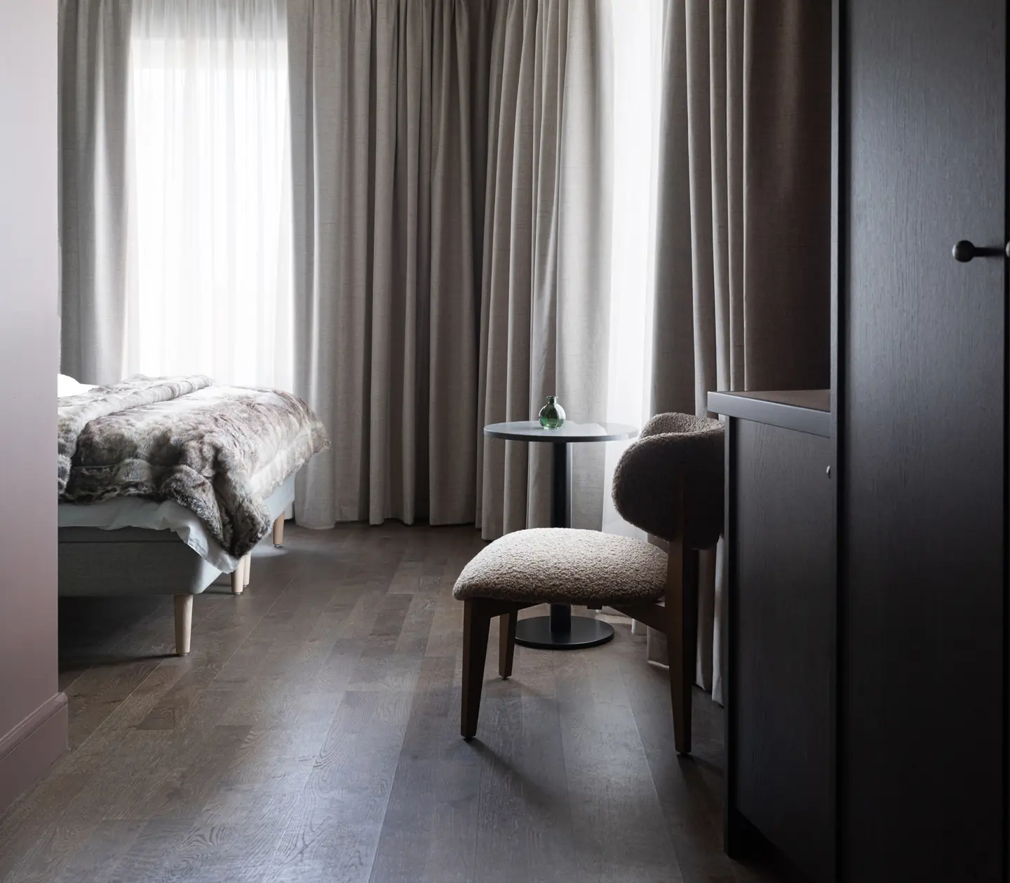 Overall view of a Standard room featuring a bed, table, and wardrobe.