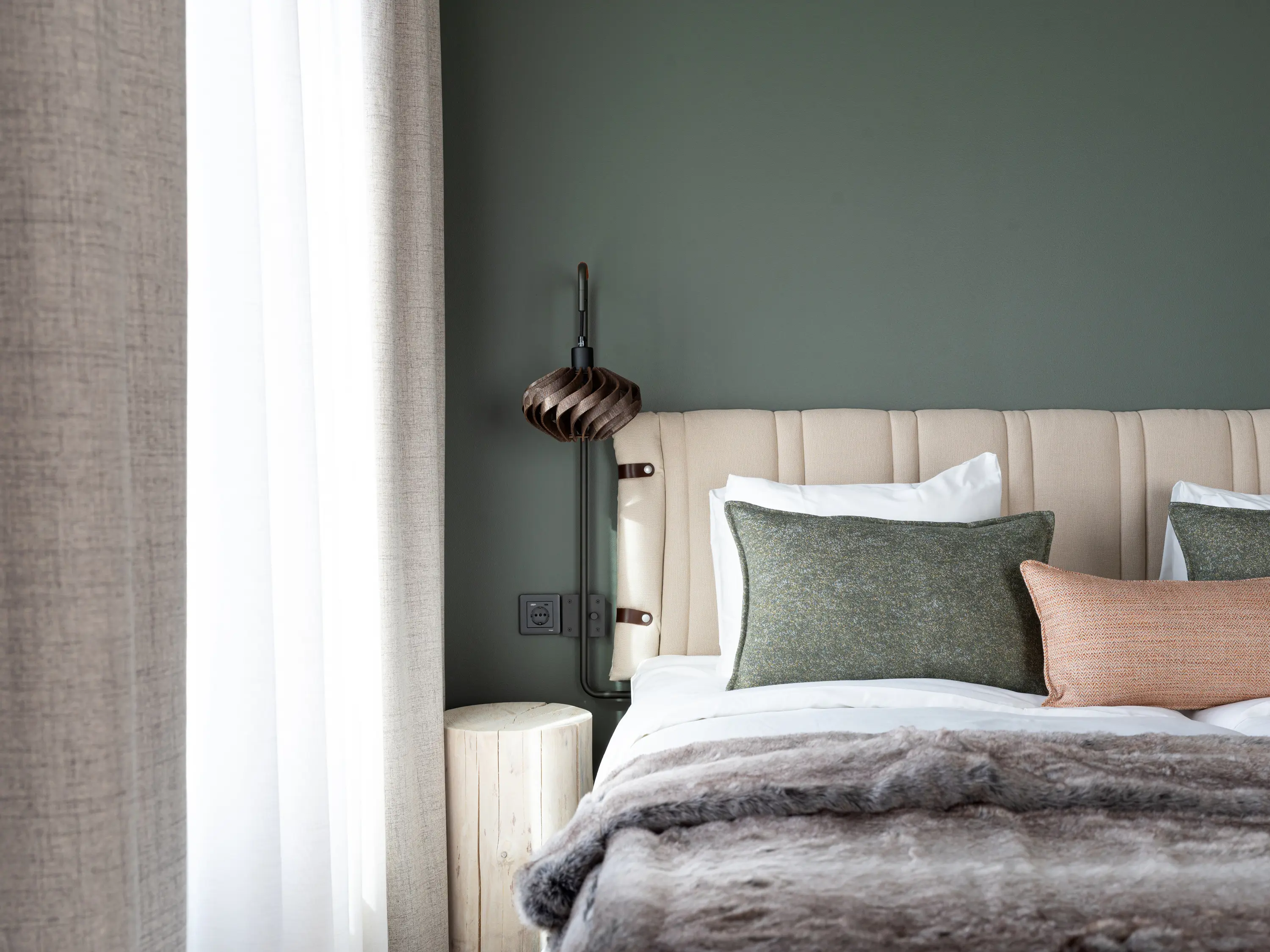 Cozy suite with bed, wardrobes, and large window.