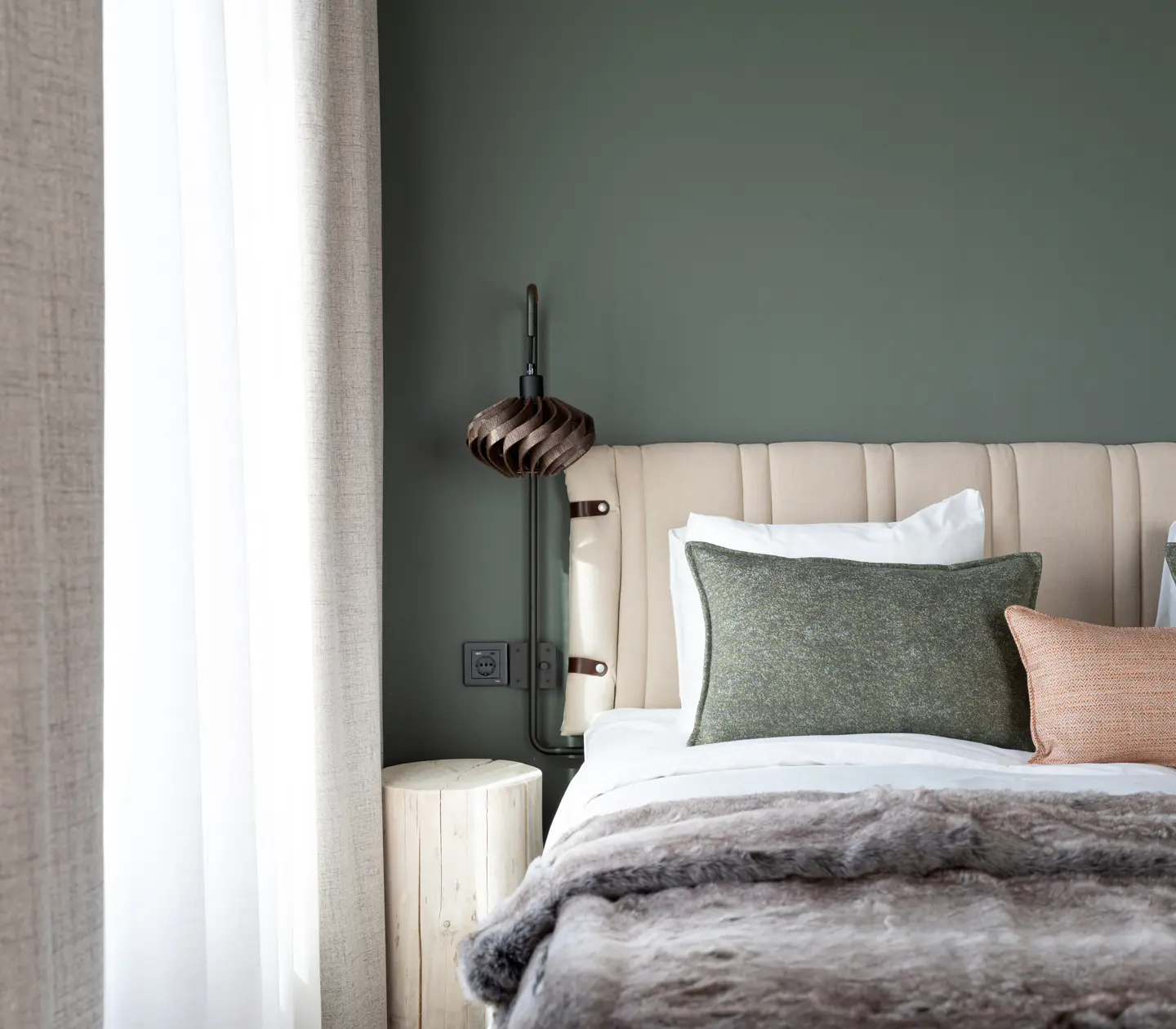 Cozy suite with bed, wardrobes, and large window.