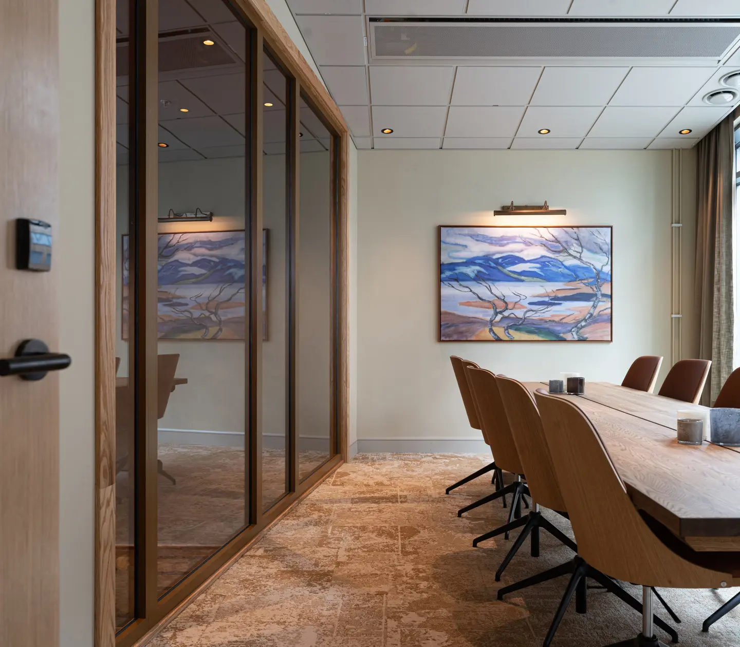 Conference facility in chairman seating with a beautiful painting on a grey wall