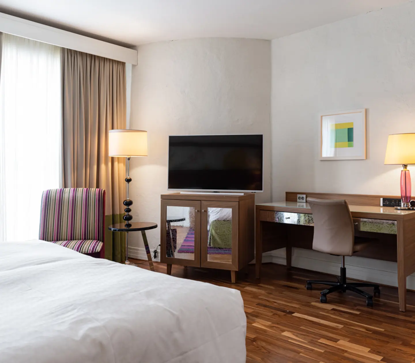 Hotel room with double bed and large headboard