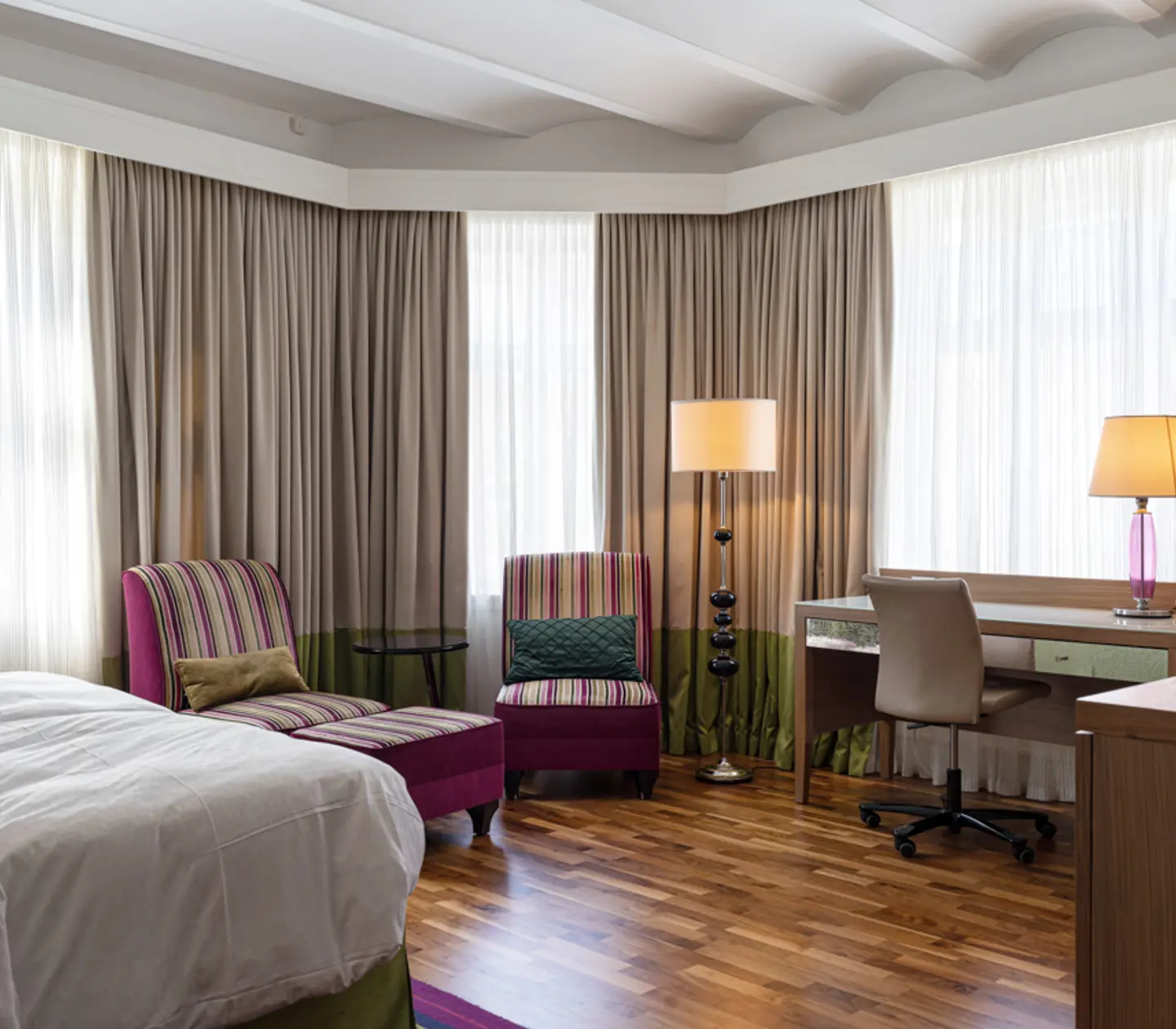 Hotel room with brick wall, TV and armchair