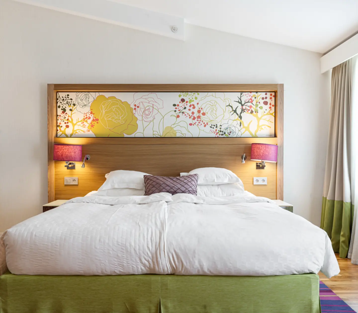 Hotel room with double bed and armchair