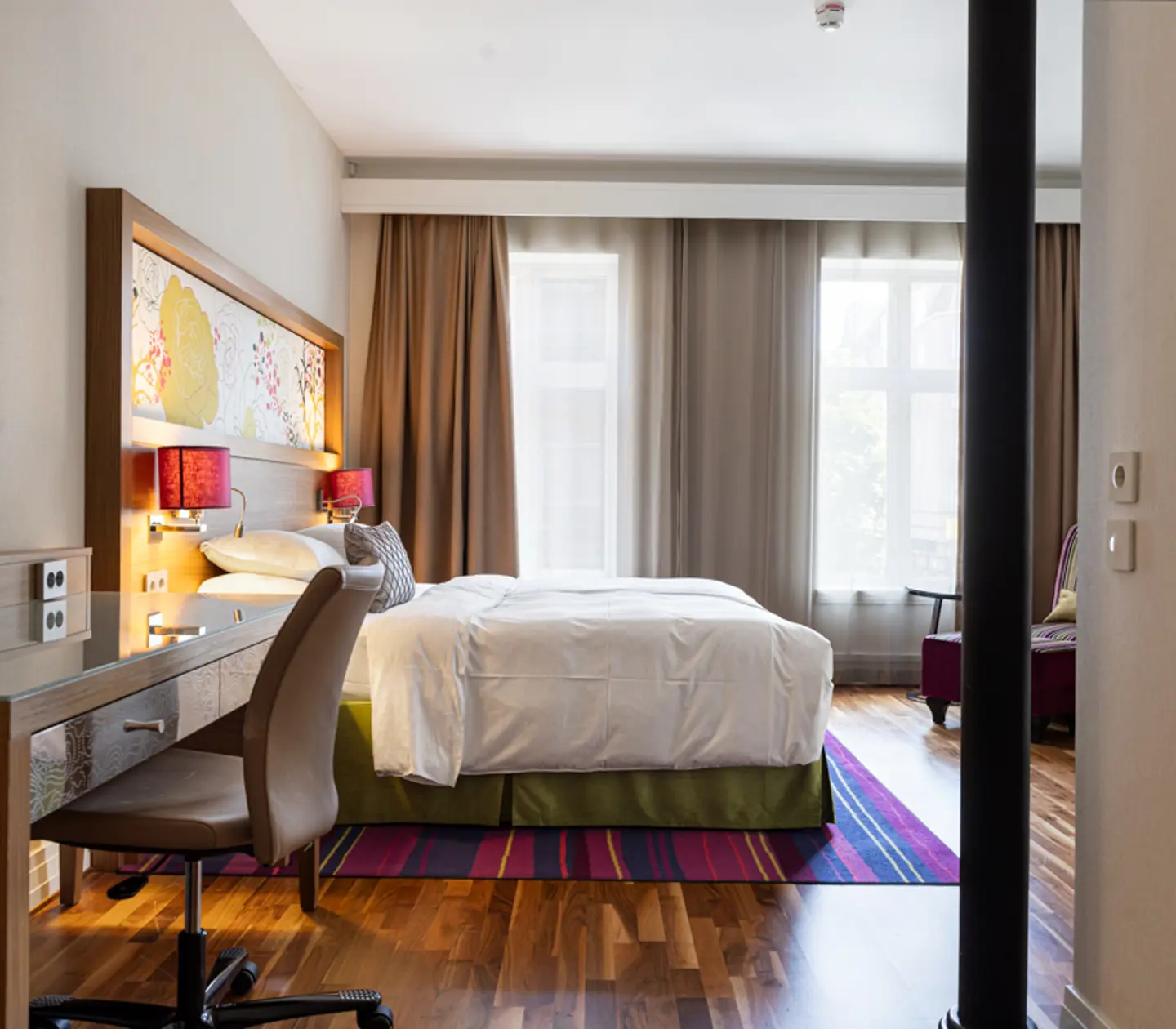 Suite with armchairs and large windows