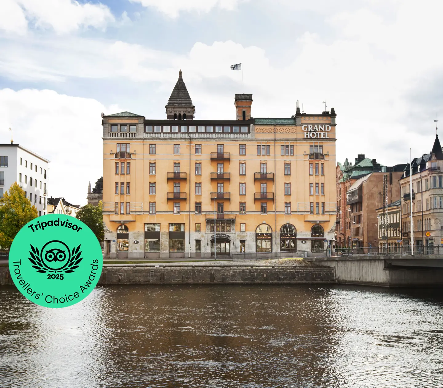 The orange facade of the Elite Grand Hotel in Norrköping with Motala Ström in front