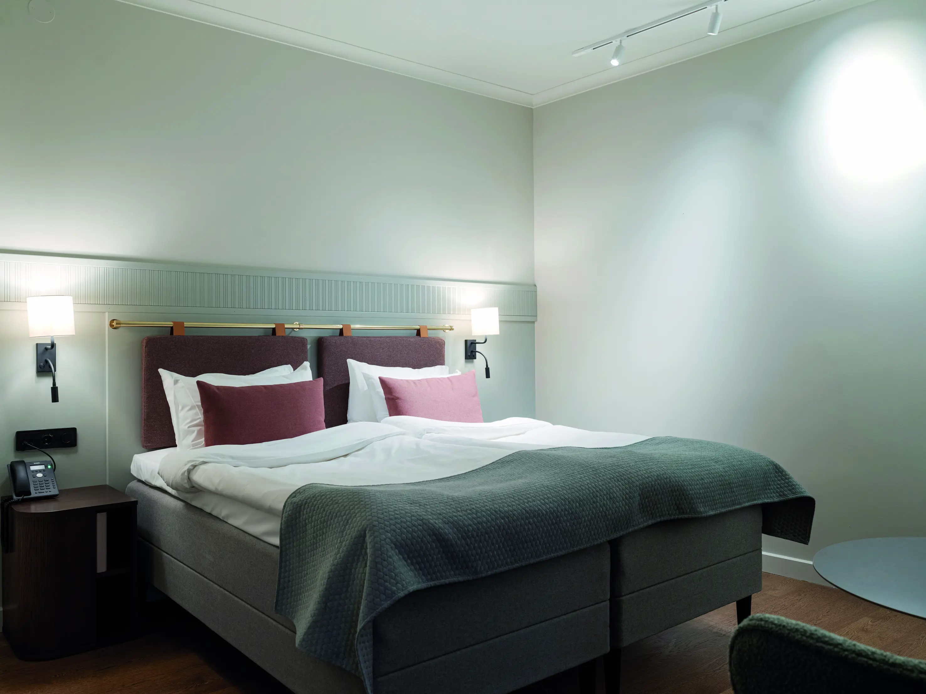 Double bed in a nicely lit room