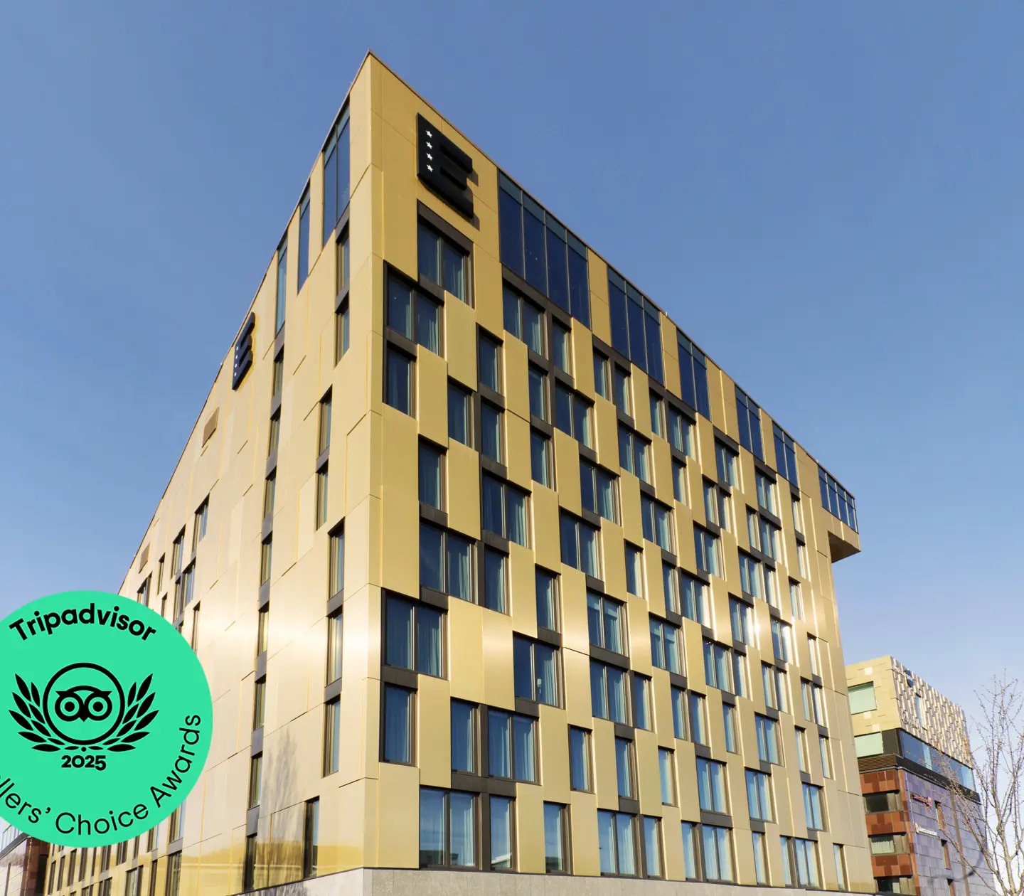 Yellow facade of Elite Hotel Academia with many windows