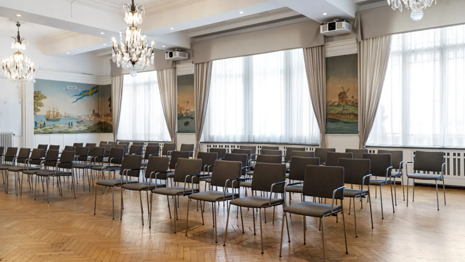 Luxurious hotel lobby with black and white checkered flooring, elegant chandeliers, large grandfather clock, and stylish seating area.